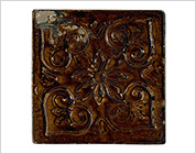 Tile with Carved Flower Design and Iron Glaze