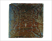 Tile with Carved Flower Design and Iron Glaze