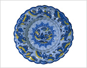 Plate Painted in Blue and Yellow with Design of Landscape and Figures (Delft Ware Faience)