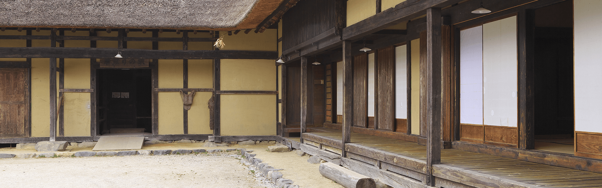 Looking from the courtyard, deep eaves and engawa surrounding the house are prominent in this traditional Japanese farm house. The house was built by a wealthy farmer in Tono, Iwate, in the late 19th century.
