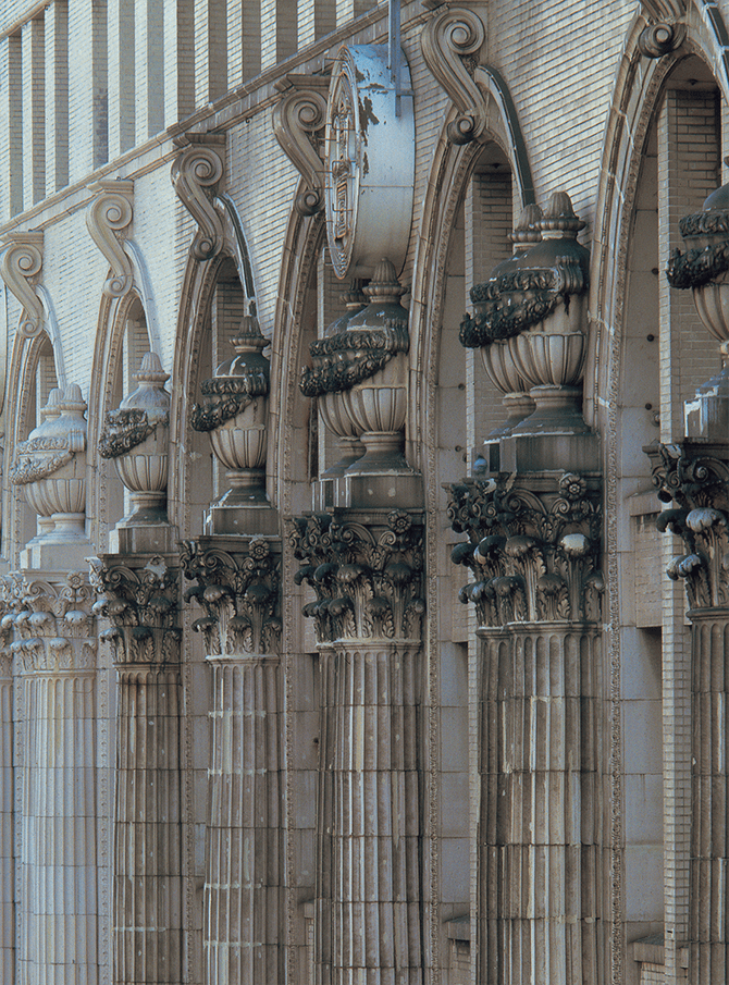 Terracotta decoration of elaborate vases on top of a series of fluted Corinthian pilasters with acanthus capitals produced by Ina Seito (INAX) for the Takashimaya Osaka department store building, built in 1932.